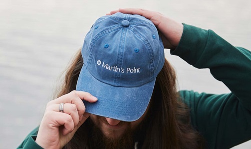 Employee wearing denim Martin's Point hat
