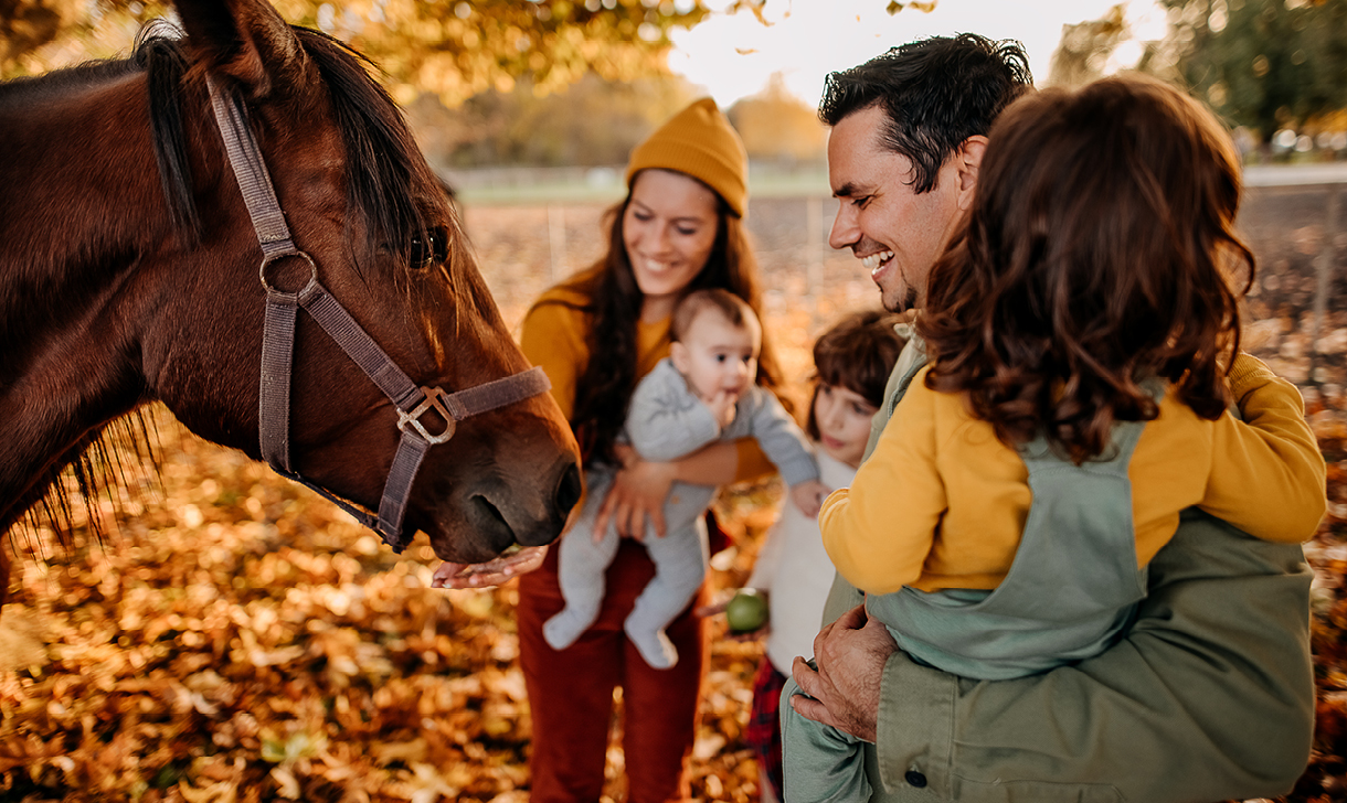 young family with horse on fall day