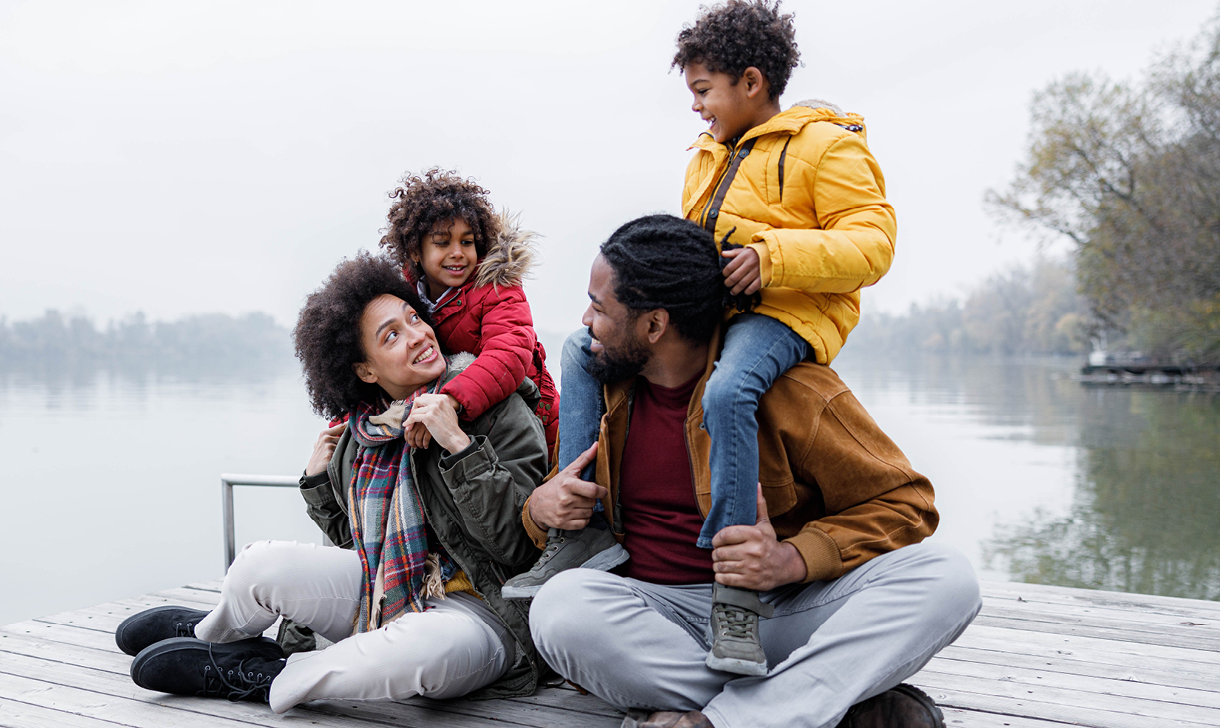 young family on dock by lake