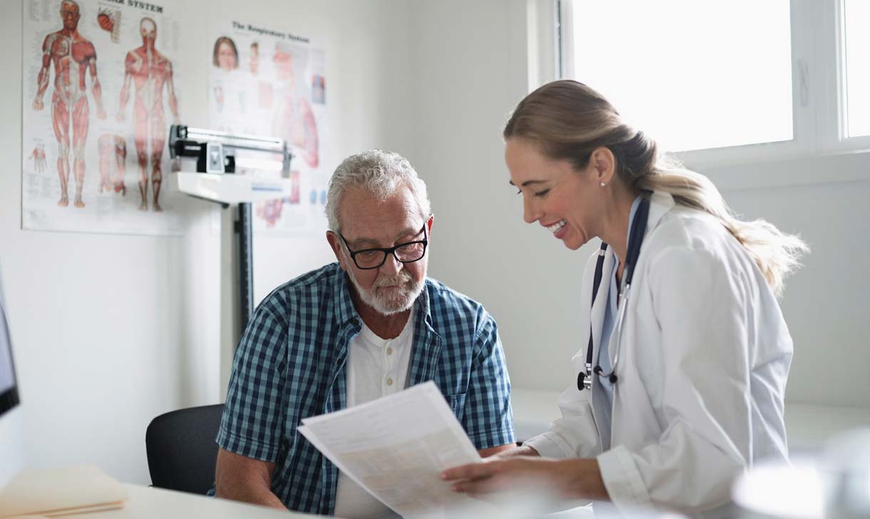 doctor discussing chart with senior patient