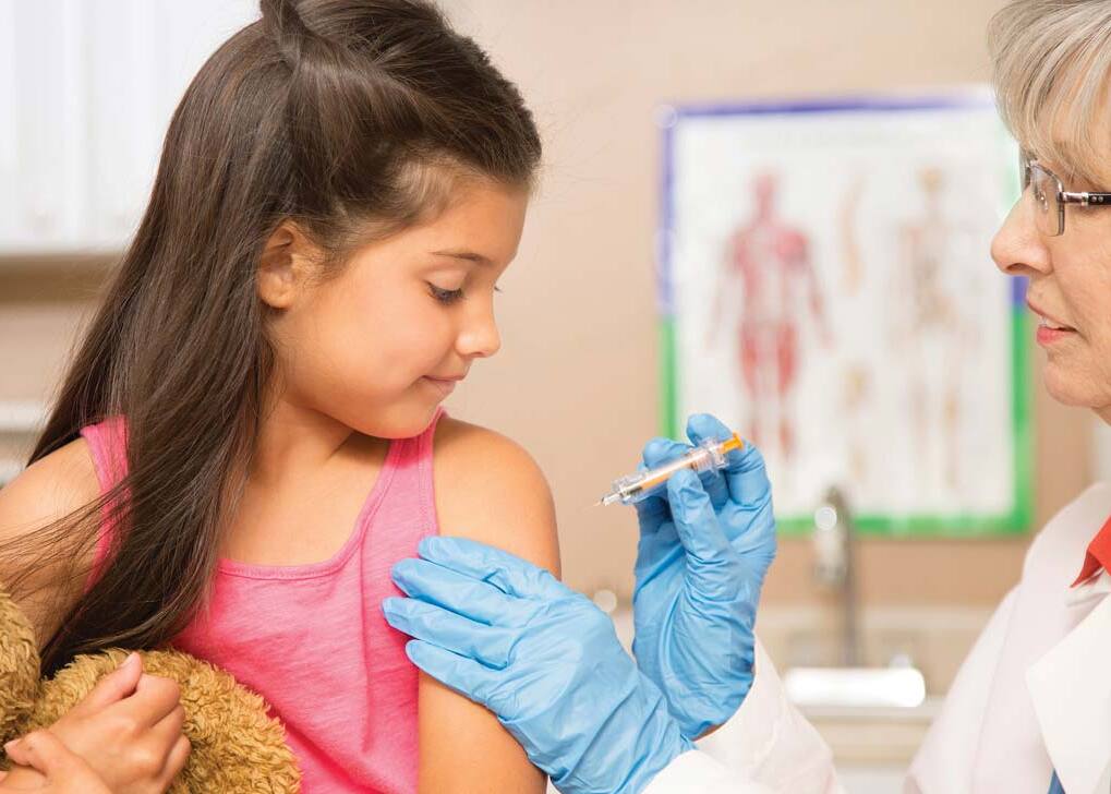 young girl receiving flu vaccine