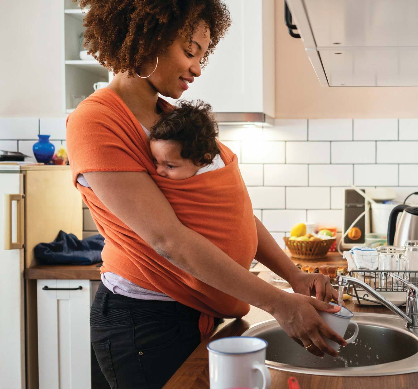 young woman with baby in kitchen