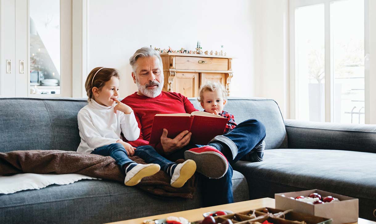 Grandfather reading to children
