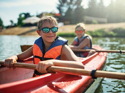 children in a kayak on the water