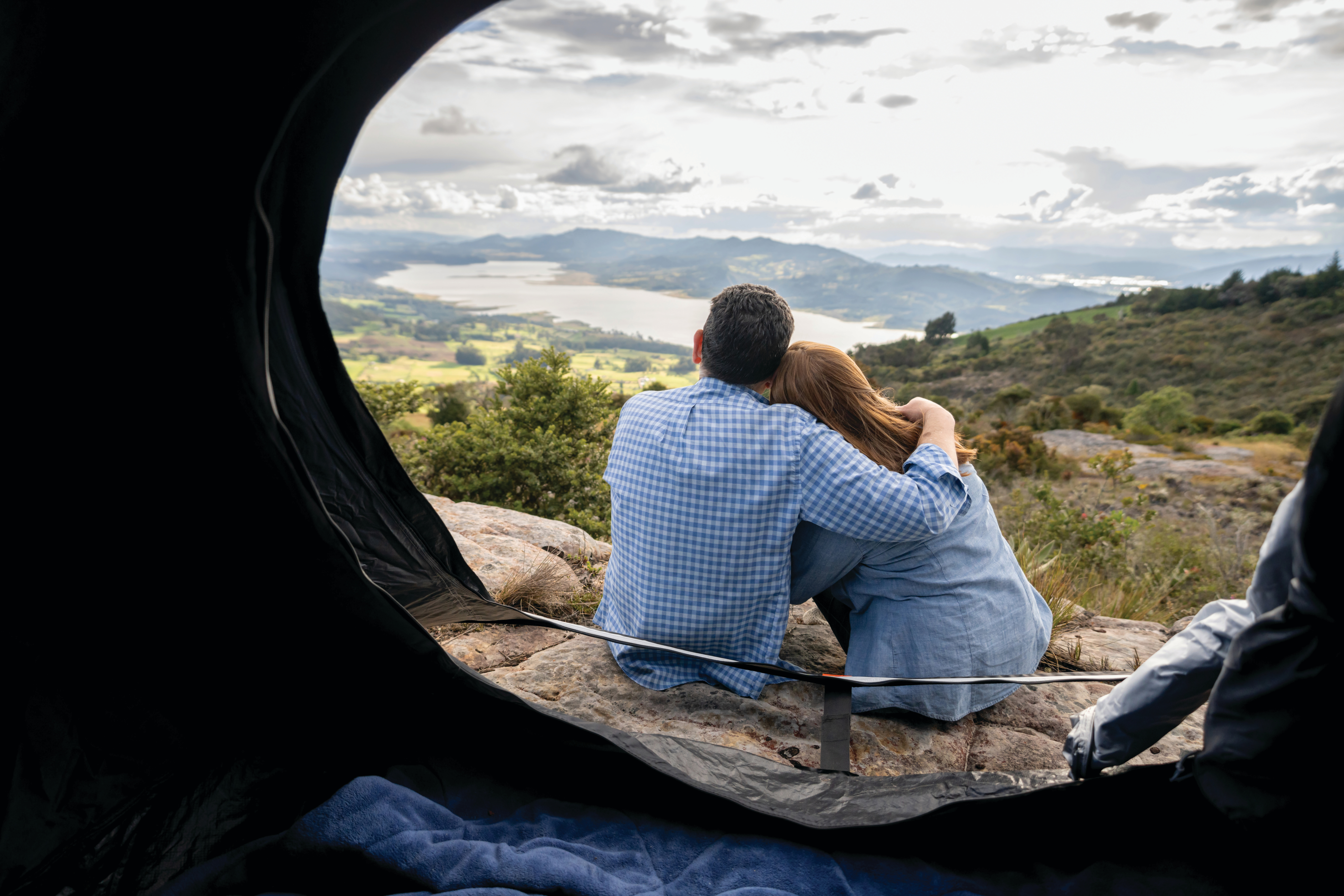 Senior couple camping on hilltop