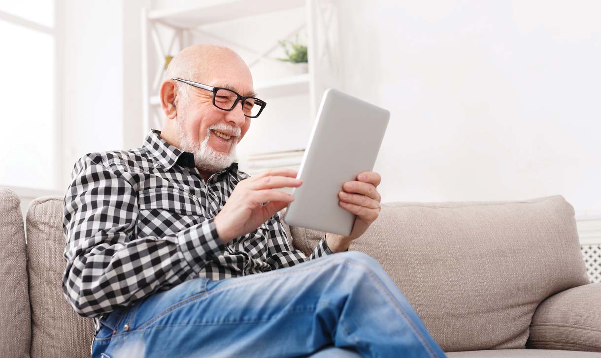 Man with tablet on sofa