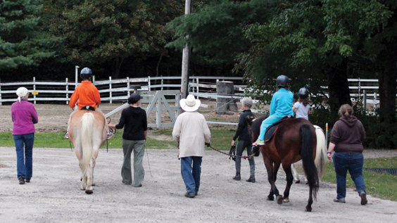 volunteers and horseback riders
