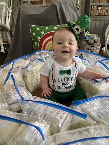Baby surrounded by moms donated breast milk.