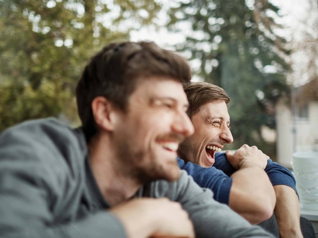 Male friends laughing together