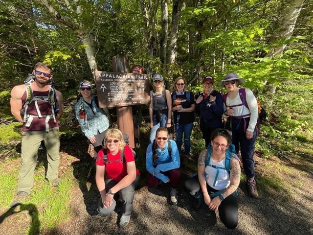 Participants of The Summit Project posing around Appalachian Trail sign
