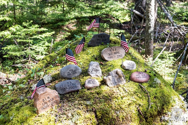 Stones for soldiers displayed with small American flags