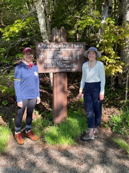 Two participants posing around Appalachian Trail sign