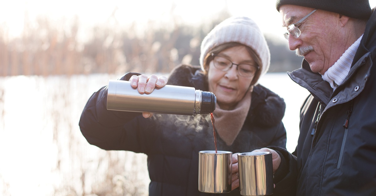 Elderly couple outside with warm drink