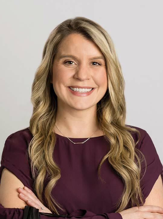 Angelea Nannicelli, AGPCNP, smiling with arms crossed.