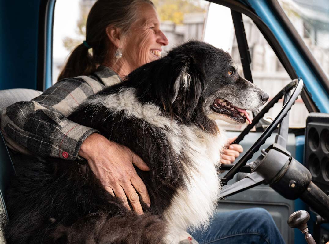 women in farm truck with dog