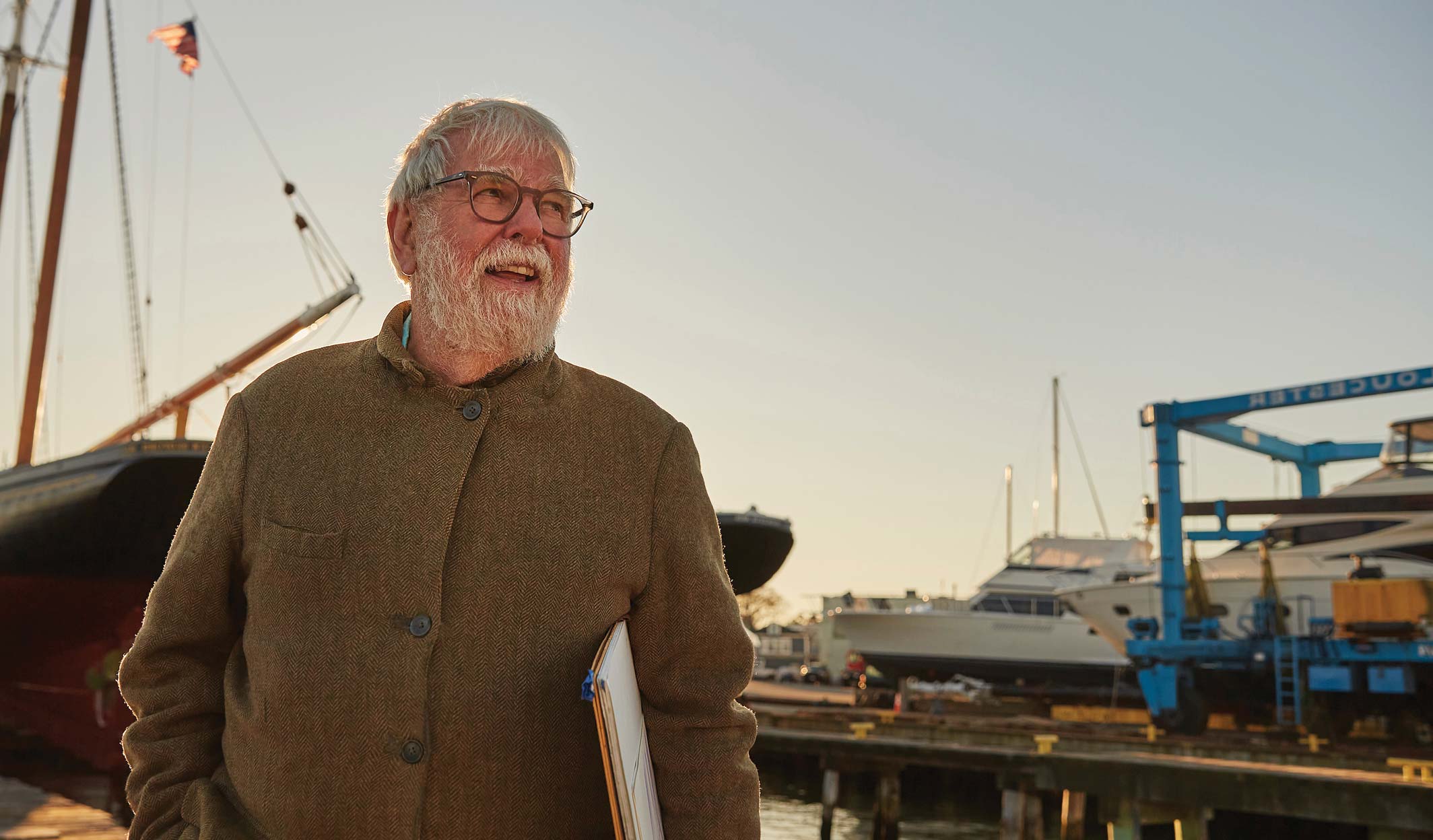 senior man on a dock near sailboat