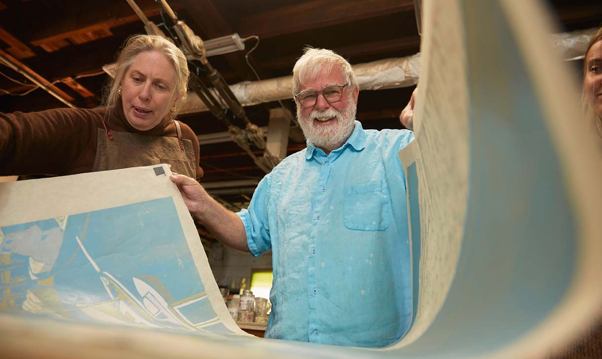 man and woman looking at old maps