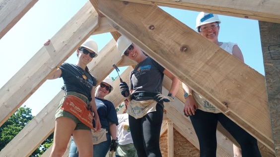 women volunteers building a home