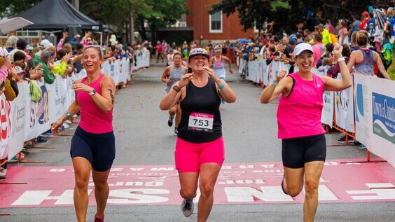 Tri for a Cure runners cross finish line