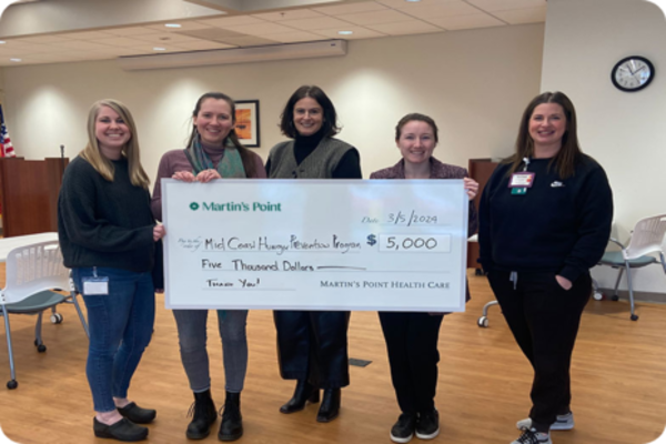 people holding donation check