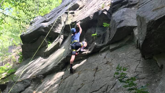 A member of the Apex Youth Connection rock climbing