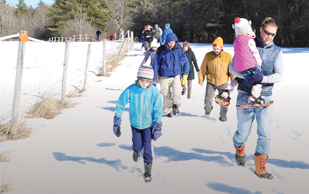 people hiking on winter trail