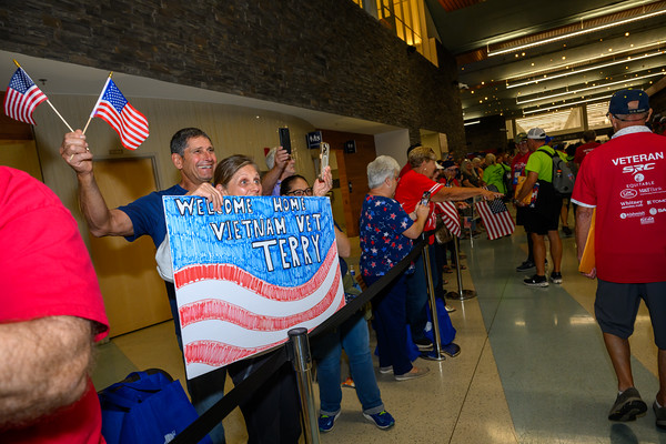 Veterans with signs at airport