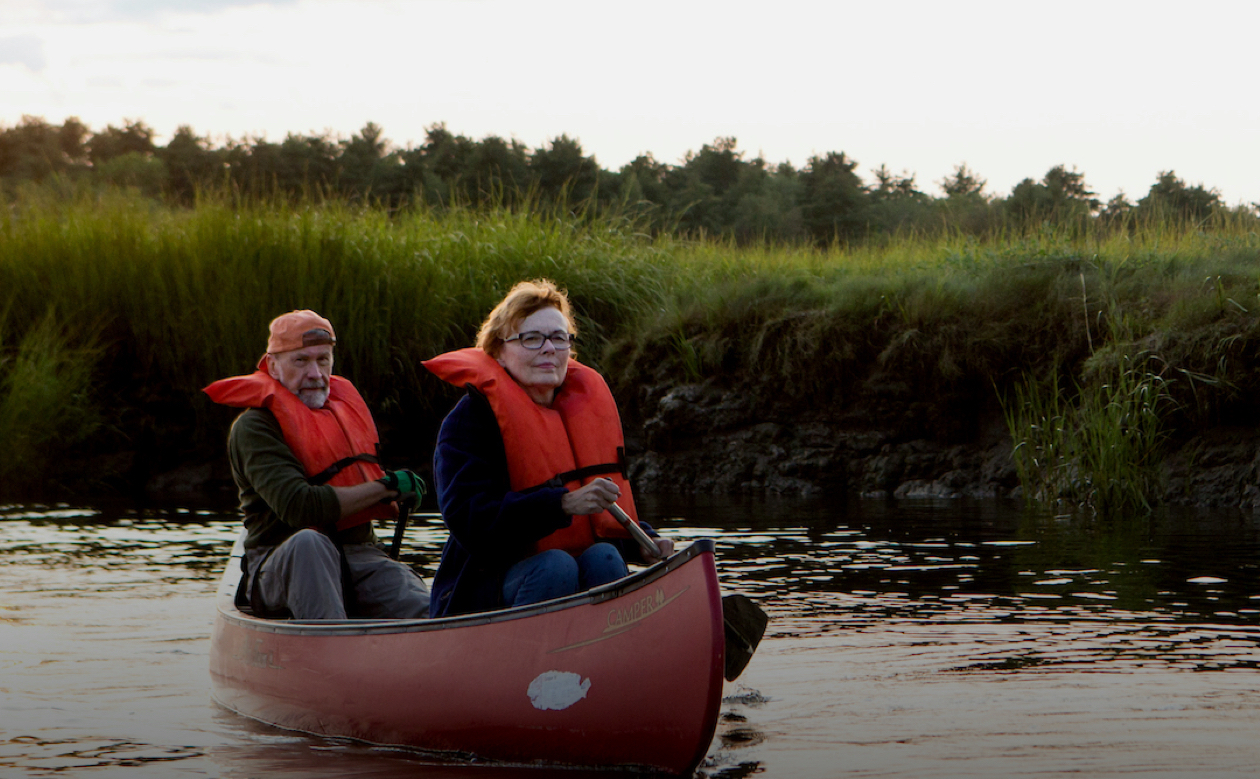 couple canoeing on river