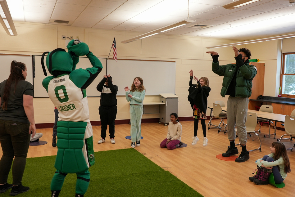 Maine Celtics player leading a class with kids