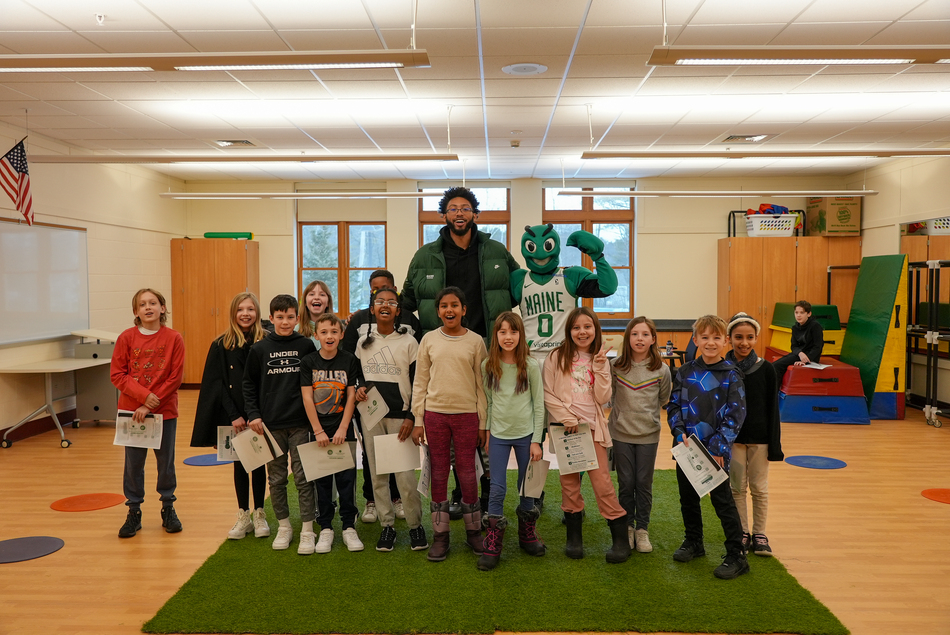 Maine Celtics player with group of kids