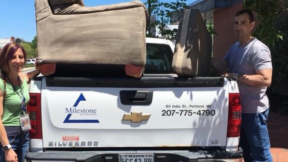 Milestone Recovery helping move furniture.