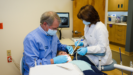 Oasis Free Clnics staff helping patient