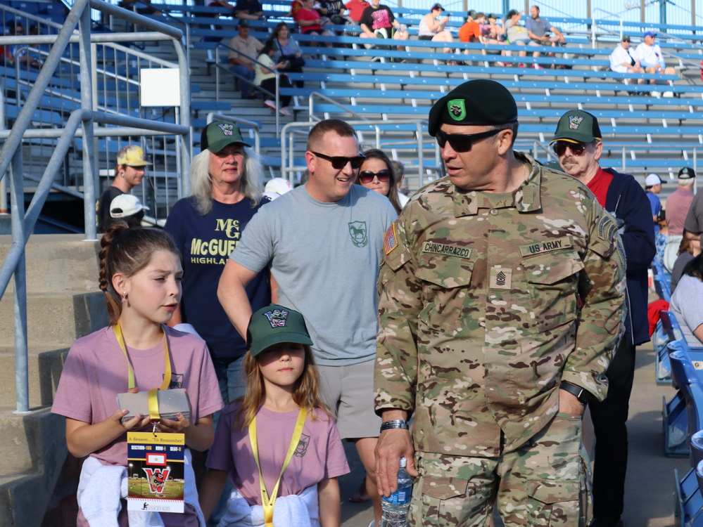 Army member with children at baseball game