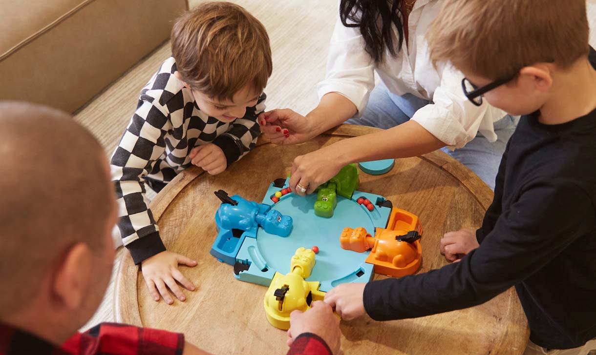 young family playing board game