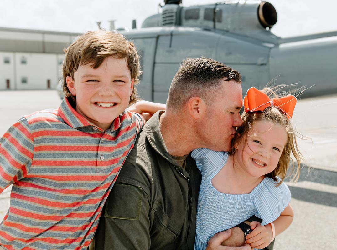 man with his two children with military plane