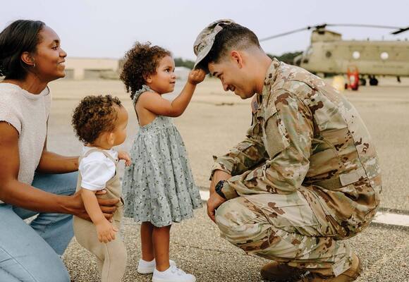 military service member greeting their family