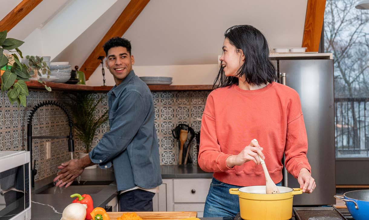 young couple making dinner