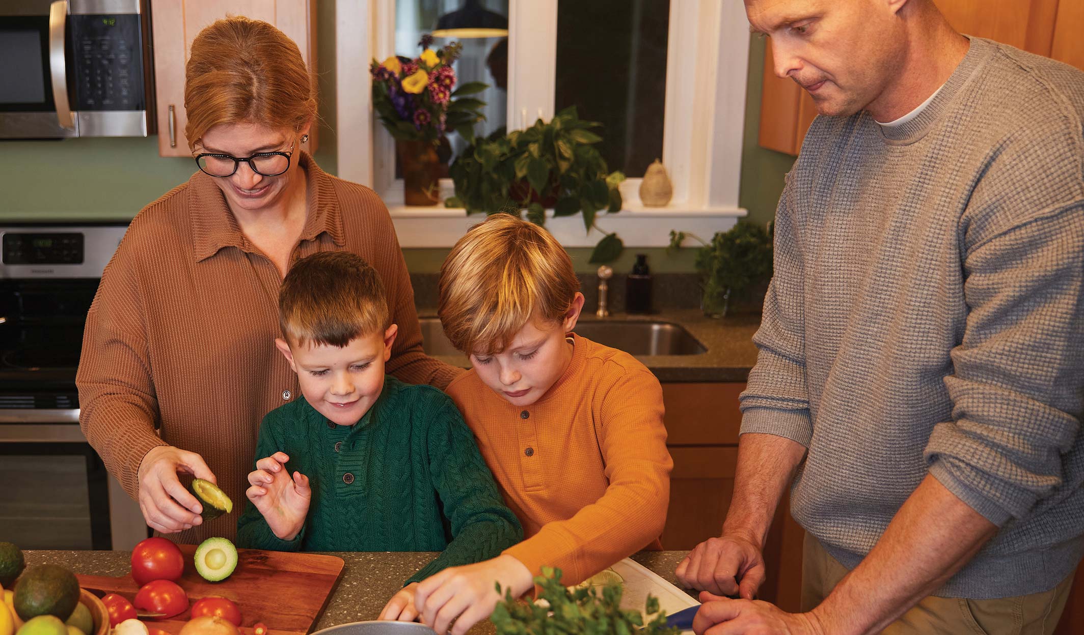 family cooking dinner in kitchen