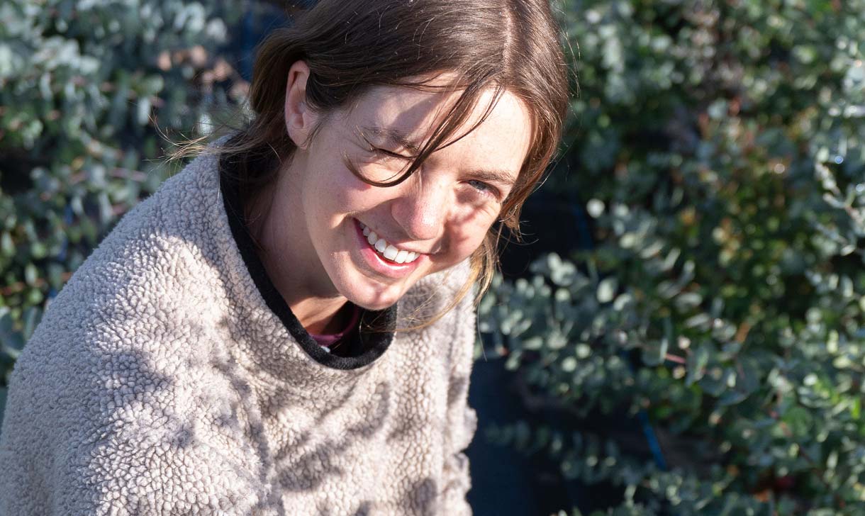 woman smiling in field outside