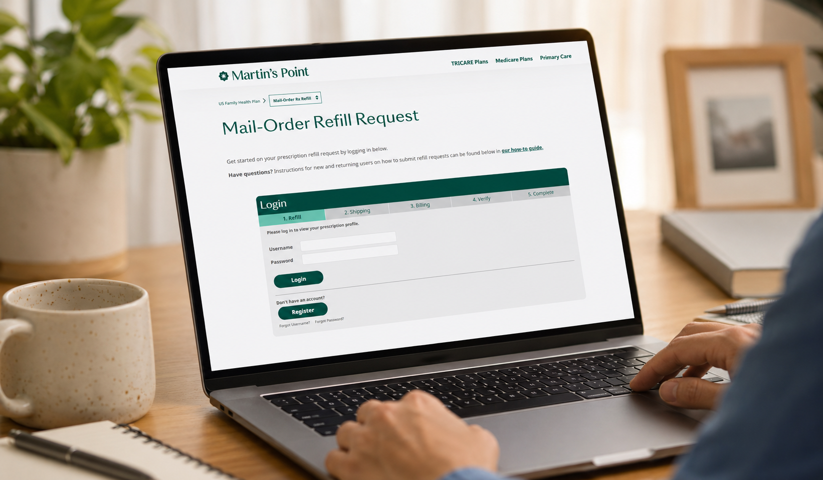 Person holding a tablet displaying the Martin’s Point Mail-Order Refill Request login page.