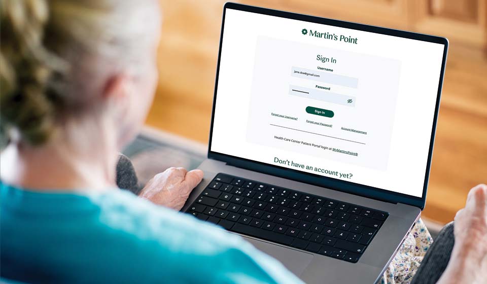 Woman using a laptop showing the Martin’s Point sign-in page.