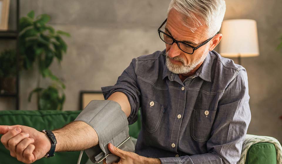 Man checking blood pressure at home