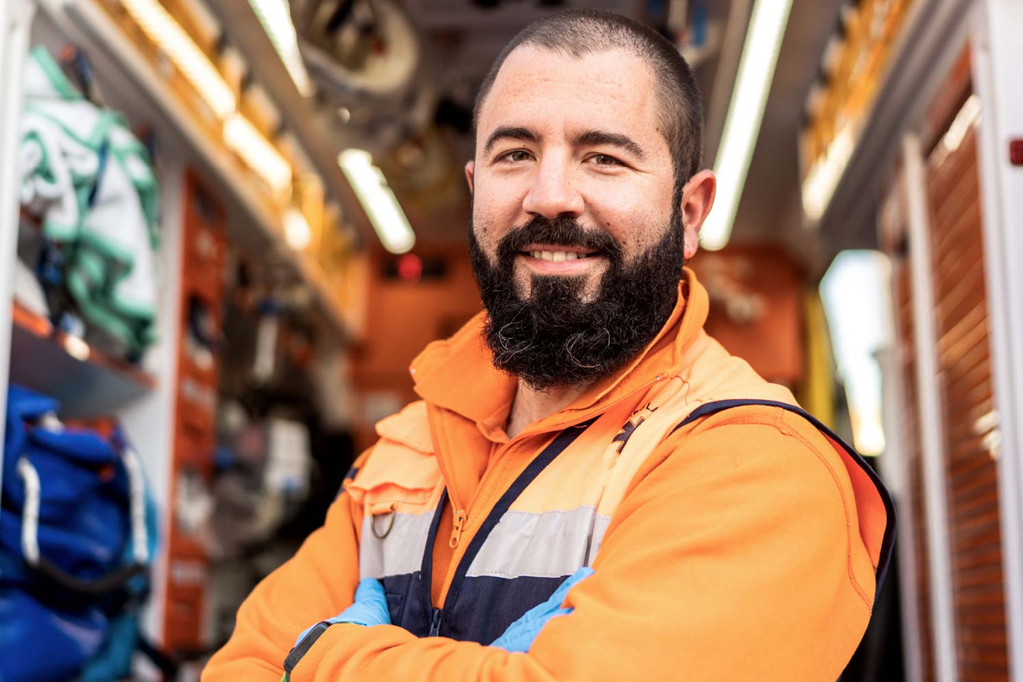 Emergency medical services professional standing inside an ambulance